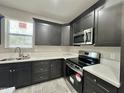 This kitchen is equipped with modern appliances, sleek cabinetry, and pristine white countertops at 11216 W Apache St, Avondale, AZ 85323