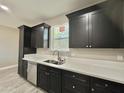 Bright kitchen features stainless steel appliances, dark cabinets, and a large window overlooking the sink at 11216 W Apache St, Avondale, AZ 85323