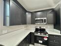 This renovated kitchen boasts modern appliances, and white countertops perfect for cooking at 11216 W Apache St, Avondale, AZ 85323