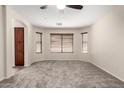 Carpeted main bedroom with ceiling fan, recessed lighting, and multiple windows at 12838 W Desert Mirage Dr, Peoria, AZ 85383