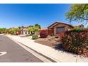 Pleasant street view showcasing a well-kept home and neighborhood landscaping at 12838 W Desert Mirage Dr, Peoria, AZ 85383