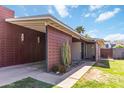 Stylish single-Gathering home featuring a carport, sleek chimney, and manicured landscaping with desert plants at 1329 E Catalina Dr, Phoenix, AZ 85014
