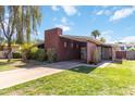 Inviting single-Gathering home boasting desert landscaping, a modern chimney design, and a convenient covered carport at 1329 E Catalina Dr, Phoenix, AZ 85014