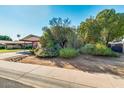 Inviting single-story home with lush, mature landscaping and a convenient covered carport at 15212 N 37Th Ave, Phoenix, AZ 85053
