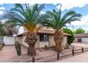 Inviting single-story brick home with desert landscaping and mature palm trees at 1643 W Naranja Ave, Mesa, AZ 85202