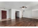 Spacious living room features beautiful wood floors and neutral walls, ready for personalization at 1643 W Naranja Ave, Mesa, AZ 85202