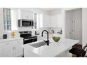 Bright kitchen featuring white cabinetry, modern stainless steel appliances, and a center island with seating at 16875 N 12Th St # 33, Phoenix, AZ 85020
