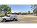 Neighborhood street view showing the property, parking, and attractive desert landscaping at 1733 N Miller Rd, Scottsdale, AZ 85257