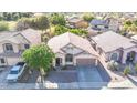 Aerial shot of the house, showing the surrounding neighborhood with mature trees at 19824 N 14Th Pl, Phoenix, AZ 85024