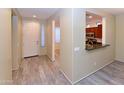 Inviting entryway features wood-look flooring, neutral paint, and a convenient pass-through to the kitchen at 21050 E Tierra Grande --, Queen Creek, AZ 85142