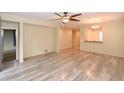 Expansive living room featuring modern wood flooring, a ceiling fan, and neutral wall color at 21050 E Tierra Grande --, Queen Creek, AZ 85142
