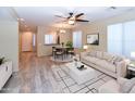 An open-concept living room with hardwood floors and a dining area at 21050 E Tierra Grande --, Queen Creek, AZ 85142