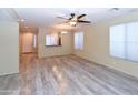 Spacious living room featuring contemporary flooring, a ceiling fan, and ample natural light at 21050 E Tierra Grande --, Queen Creek, AZ 85142