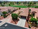 A beautiful aerial view of this home with a well manicured lawn and beautiful tile roof at 22504 N San Ramon Dr, Sun City West, AZ 85375