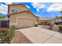 Tan single-Gathering home with a two-car garage and desert landscaping creating great curb appeal at 2327 E Edna Ave, Phoenix, AZ 85022