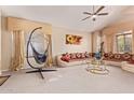 Spacious living room boasts vaulted ceilings, plush seating, and a unique hanging chair at 2327 E Edna Ave, Phoenix, AZ 85022