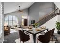 Inviting living room with vaulted ceilings, large arched window, dining area and staircase at 2340 W Myrtle Dr, Chandler, AZ 85248