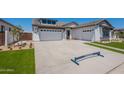Spacious driveway leading to a two-car garage in a modern single-Gathering home at 24022 S 218Th Pl, Queen Creek, AZ 85142