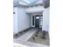 Close-up of a front door with a walkway and desert landscaping at 24088 S 218Th Pl, Queen Creek, AZ 85142