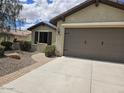 Inviting single-story home featuring a well-maintained yard, and two-car garage at 27158 W Potter Dr, Buckeye, AZ 85396