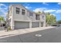 Exterior view of condo building with multiple garages, neutral color scheme, and well-maintained landscaping at 3076 E Dunbar Dr, Phoenix, AZ 85042