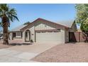 Single-story house featuring a two-car garage with a desert-landscaped front yard at 3300 N Coronado St, Chandler, AZ 85224