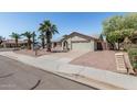 Inviting single-story home featuring a two-car garage and mature palm trees at 3300 N Coronado St, Chandler, AZ 85224