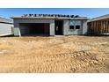 New home construction showing the front of the garage with roofing materials stacked and ready for completion at 46904 W Coe St, Maricopa, AZ 85139