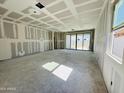 Bright, unfinished living room with large sliding glass door and windows awaiting customization at 46904 W Coe St, Maricopa, AZ 85139