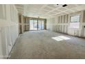 Spacious living area under construction, featuring sliding glass doors and large windows for natural light at 46904 W Coe St, Maricopa, AZ 85139