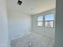 A well-lit bedroom space with bright white walls and large windows at 47333 W Coe St, Maricopa, AZ 85139