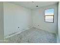 Bright bedroom featuring fresh paint and a large window overlooking outdoors at 47333 W Coe St, Maricopa, AZ 85139