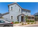 Charming two-story home featuring a combination of gray and brown siding with manicured landscaping at 4833 S Ferric --, Mesa, AZ 85212