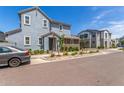 Charming two-story home featuring a combination of gray and brown siding with manicured landscaping at 4833 S Ferric --, Mesa, AZ 85212