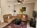 Cozy living room with plush seating, ceiling fan, and a neutral color palette at 520 S Evergreen Rd, Tempe, AZ 85288