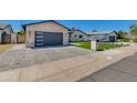 Charming exterior features brick accents, gray garage door, and well-manicured lawn at 5425 E Avalon Dr, Phoenix, AZ 85018