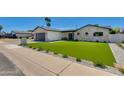 Beautiful home exterior with brick accents, manicured lawn, and modern design elements at 5425 E Avalon Dr, Phoenix, AZ 85018