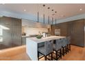 A modern kitchen featuring a large island with seating, sleek countertops, and custom cabinetry at 6142 E Alta Hacienda Dr, Scottsdale, AZ 85251
