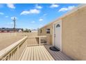 This backyard features a wooden deck and railing, plus a back door leading into the home at 633 S 96Th St, Mesa, AZ 85208