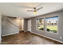 Bright living area with large windows, wood-look flooring and staircase at 6743 S Jentilly Ln, Tempe, AZ 85283
