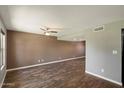 Open-concept living room with neutral walls and stylish wood-look tile flooring at 6743 S Jentilly Ln, Tempe, AZ 85283