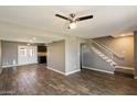 Inviting living room features wood-look tile floors and a staircase leading to the upper level at 6743 S Jentilly Ln, Tempe, AZ 85283