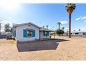Cozy bungalow with shuttered windows and desert surroundings at 813 N Gilbert Ave, Casa Grande, AZ 85122