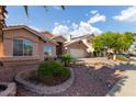 Charming single-story home with a well-maintained front yard with desert landscaping at 8606 W Caribbean Ln, Peoria, AZ 85381