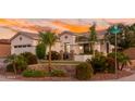 Charming single-story home with desert landscaping, stone accents, and a welcoming front entrance at sunset at 9721 E Juanita Ave, Mesa, AZ 85209