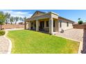 Expansive backyard featuring a covered patio and well-maintained green lawn at 1022 N Kirby St, Gilbert, AZ 85234