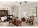 Inviting living room with neutral carpet, furniture, and an open doorway to other areas at 1022 N Kirby St, Gilbert, AZ 85234