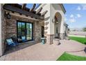 Inviting outdoor patio with comfortable seating, a pergola, and beautiful brick accents at 10448 E Glencove St, Mesa, AZ 85207