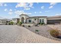 Beautiful exterior view of a single story home with a brick driveway and well-maintained landscaping at 10448 E Glencove St, Mesa, AZ 85207