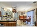 Well-equipped kitchen with stainless steel appliances and ample counter space, open to the dining area for easy entertaining at 11144 N 109Th Way, Scottsdale, AZ 85259